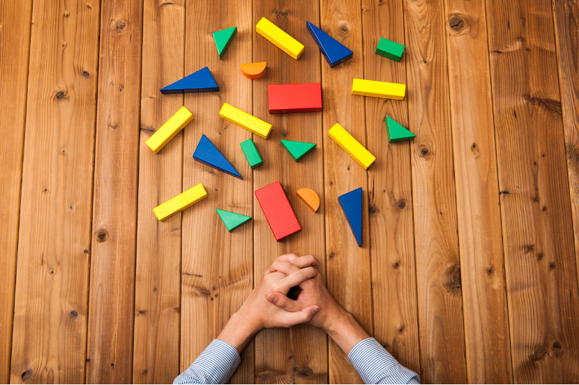 Scattered colorful blocks symbolizing fragmented systems and operational complexity